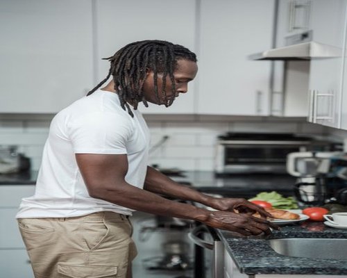 Adult man in a modern Romanian kitchen preparing a simple healthy meal